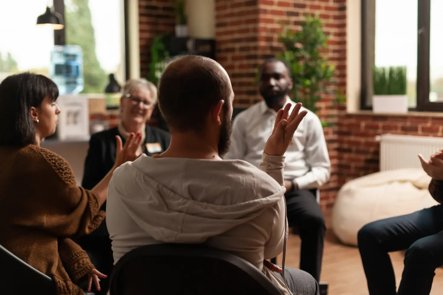 A group of people in an AA meeting