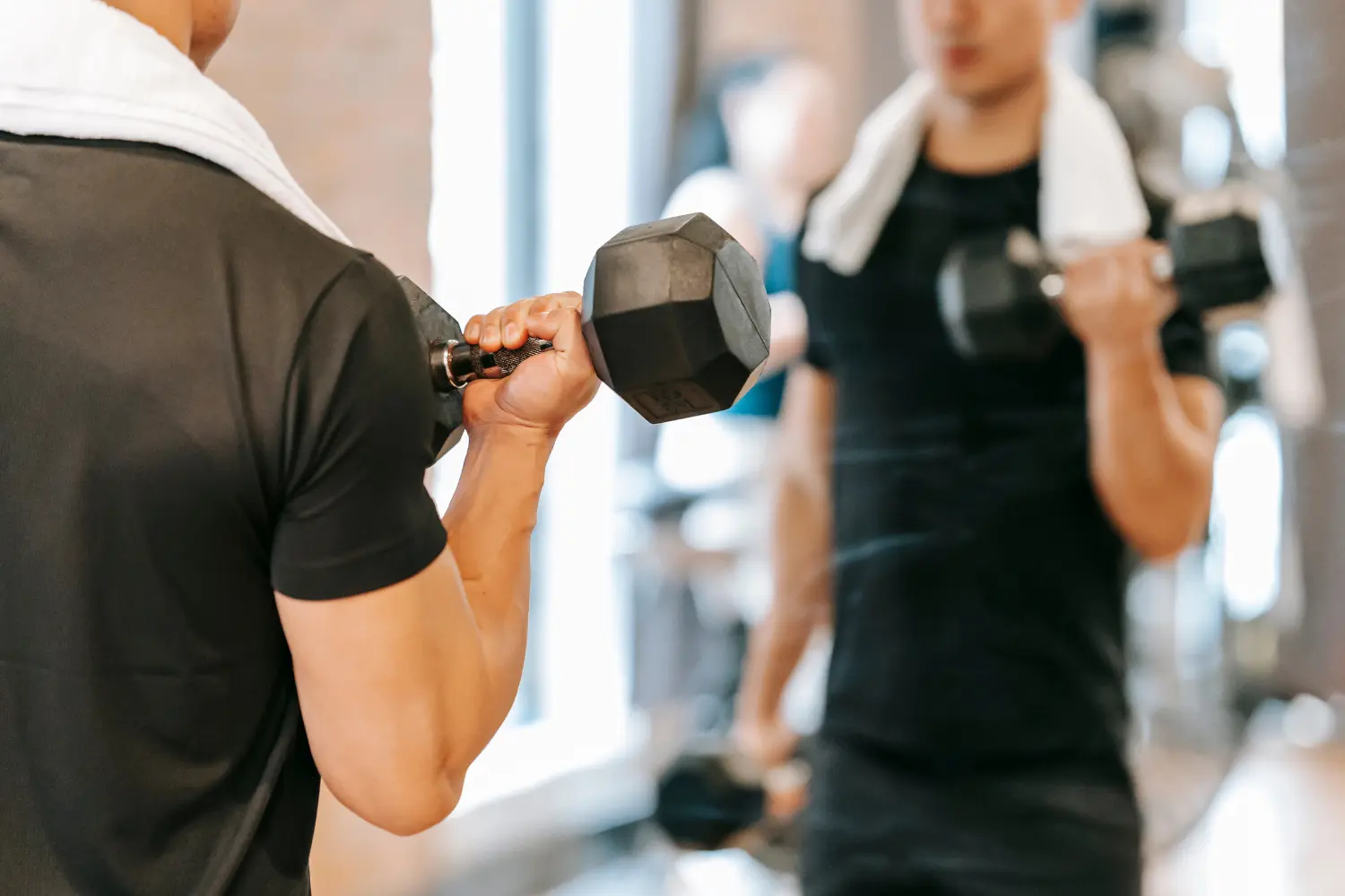 a man performing fitness training in front of a mirror