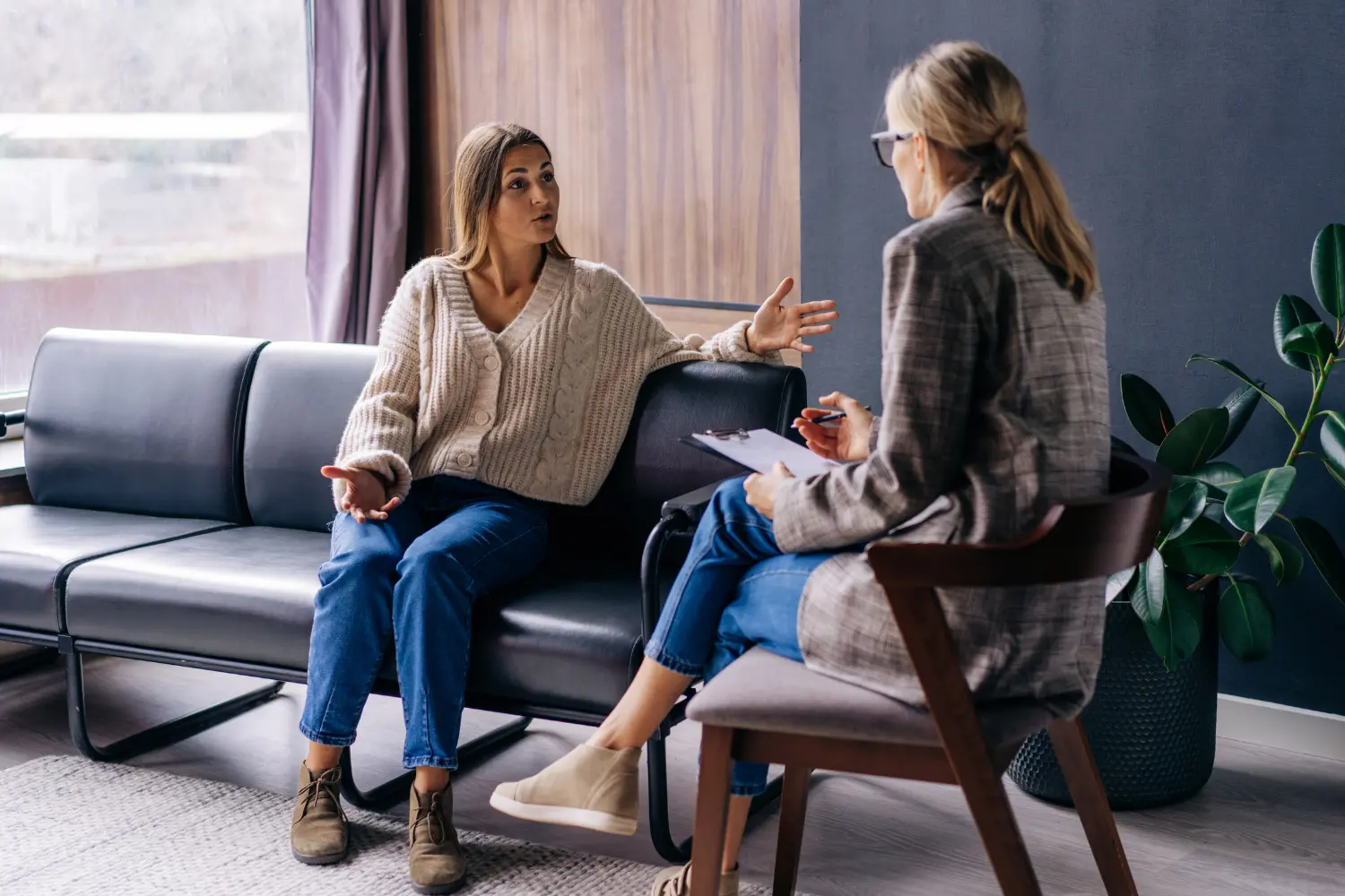 a woman and a therapist engaging in conversation during their therapy session