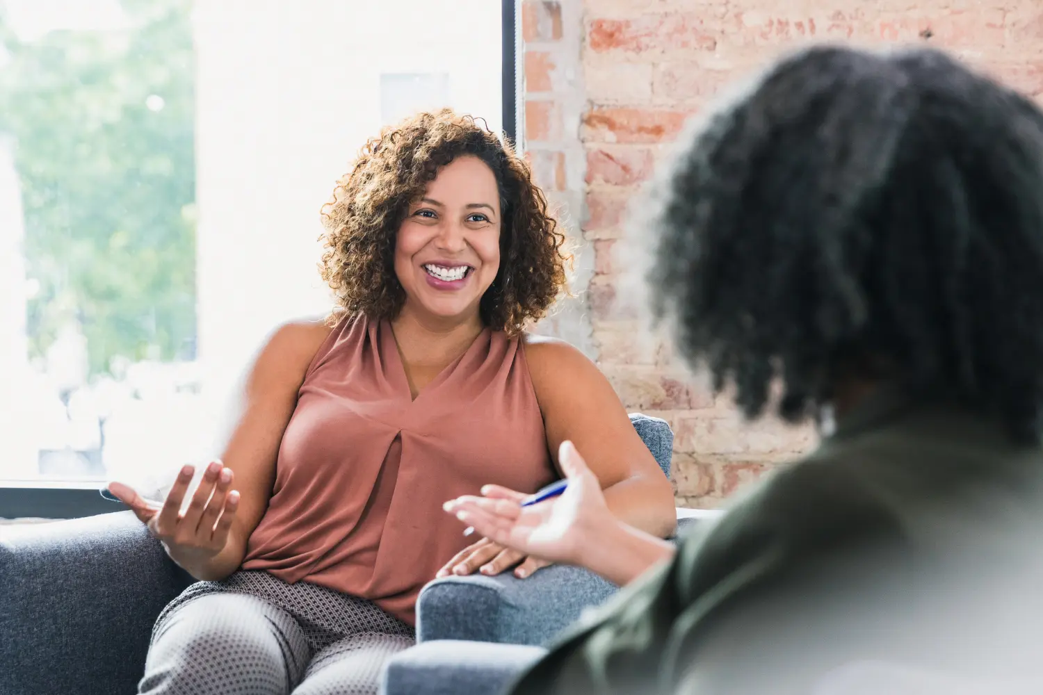 a woman happily talking to her therapist