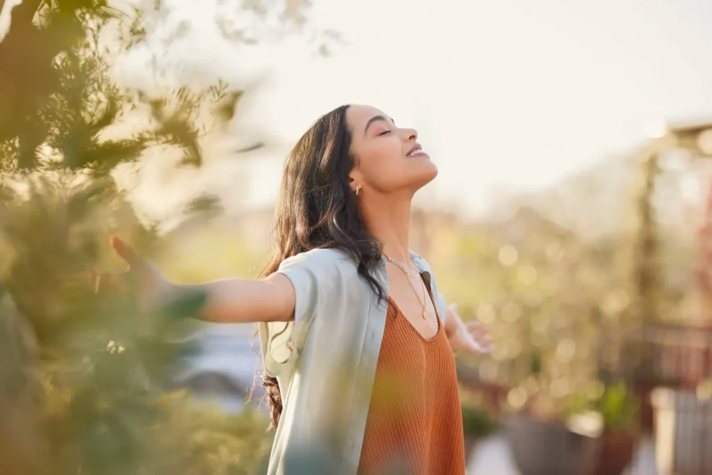 a woman with her arms open enjoying peace