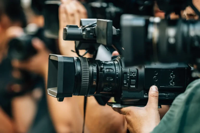 close up of a professional camera being held for a press recording