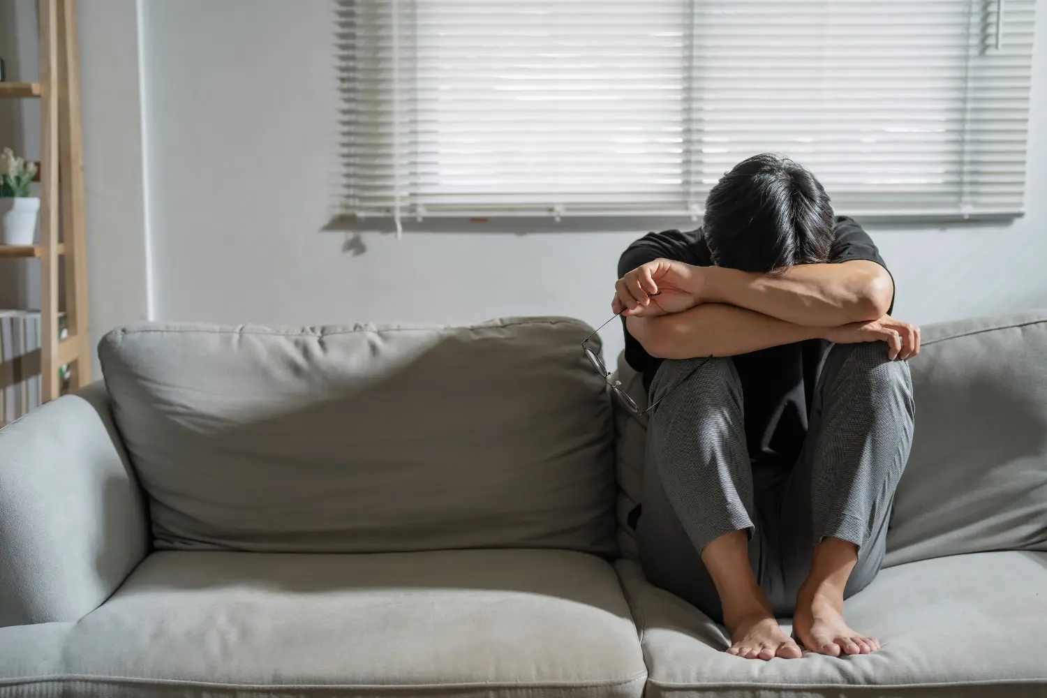 man on his couch with anxiety