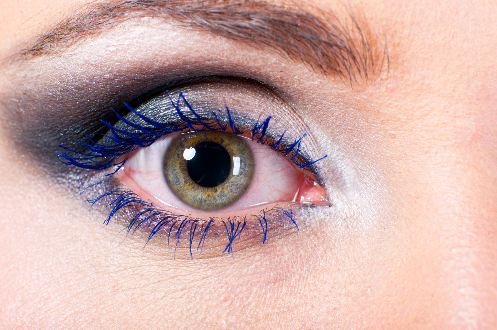 a woman's eye with big pupils, possibly due to drugs