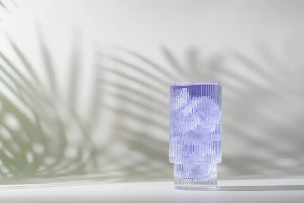 What Is Dirty Sprite? A glass of light purple liquid and ice cubes.