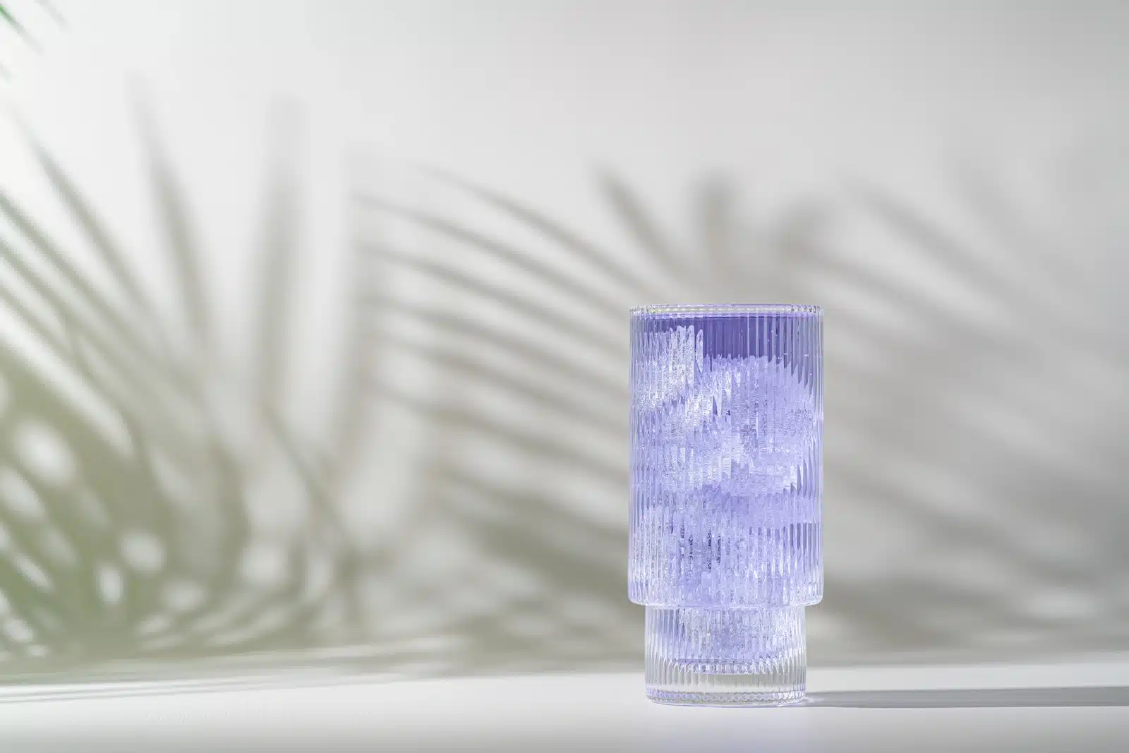 What Is Dirty Sprite? A glass of light purple liquid and ice cubes.