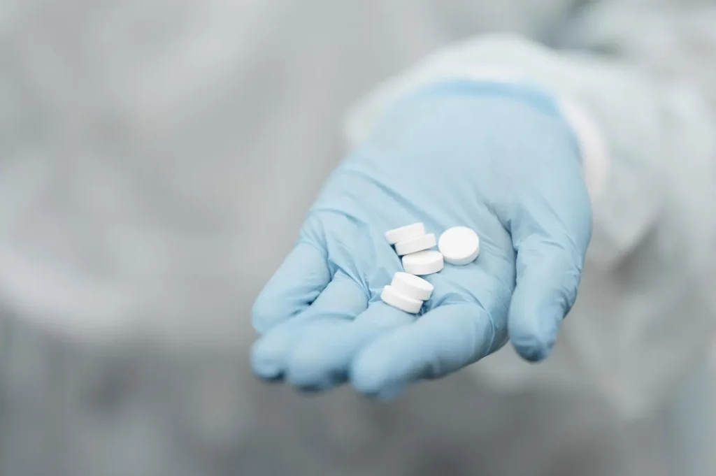 How does gabapentin make you feel? Hand holding tablets.